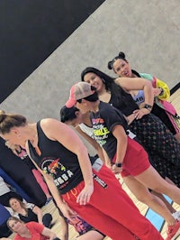 a group of people standing on a basketball court