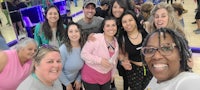 a group of people posing for a photo in a bowling alley