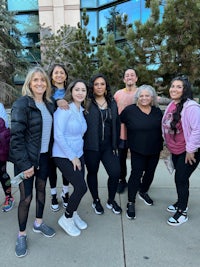 a group of people posing for a photo in front of a building