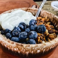 a bowl of oatmeal with blueberries and yogurt