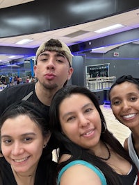 a group of people posing for a selfie in a dance studio